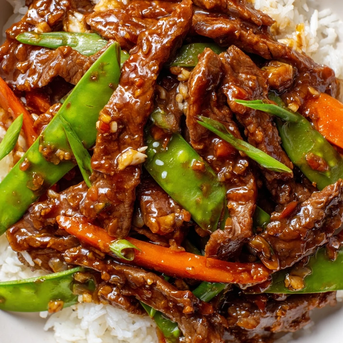 Tender beef strips, crisp snow peas, and bright carrots coated in glossy Asian-inspired sauce in this Beef Stir Fry with Snow Peas and Carrots.