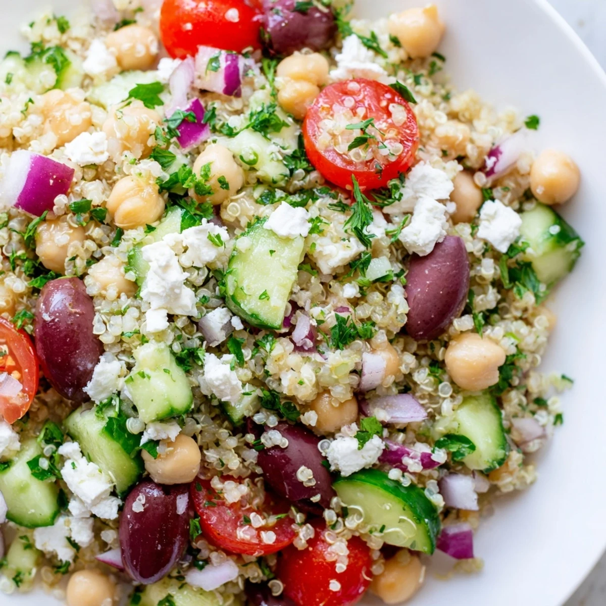 A vibrant and healthy Mediterranean Quinoa Salad featuring chickpeas, colorful vegetables, and fresh herbs, ready to serve.