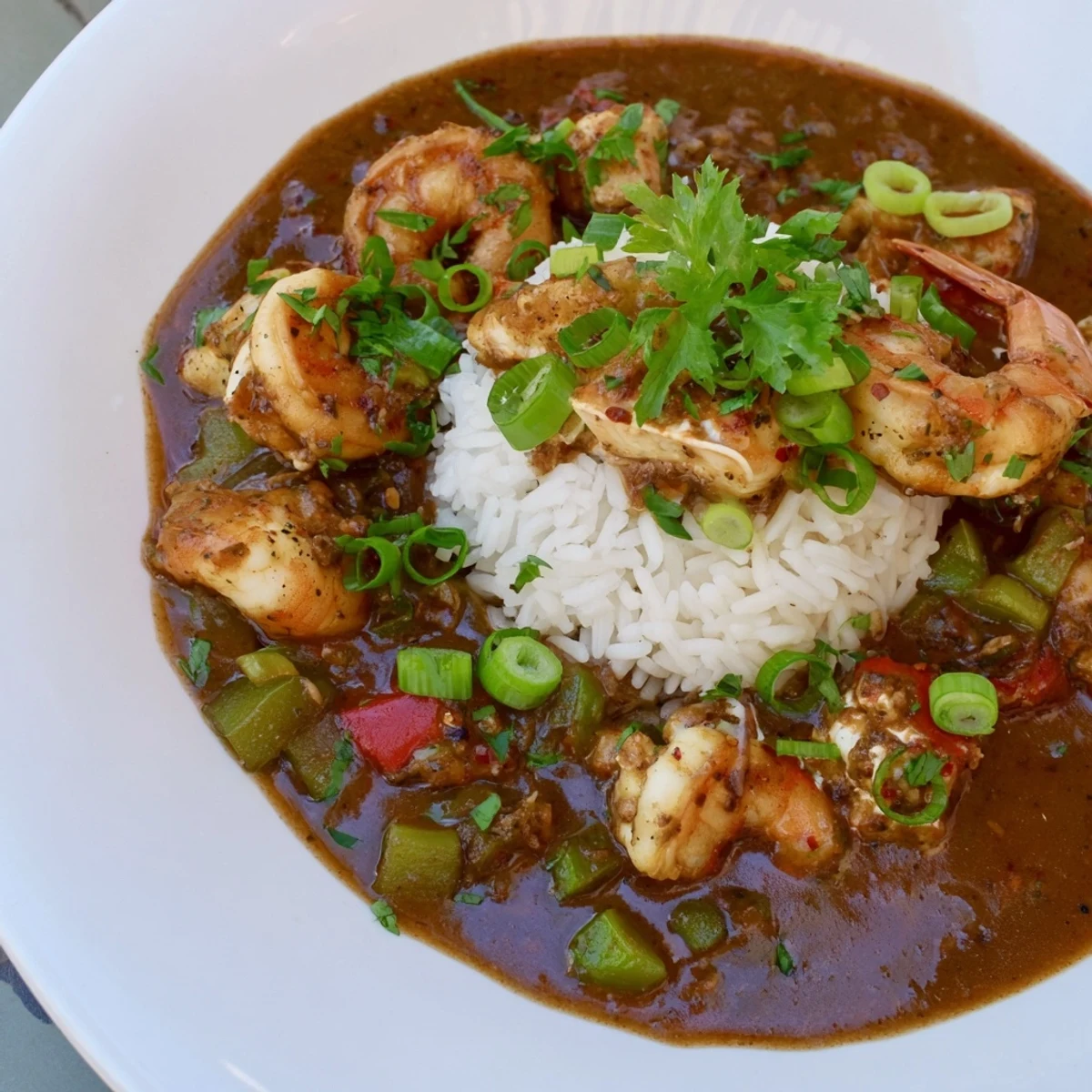 Steaming Creole Seafood Gumbo in a rustic bowl, filled with tender shrimp, crab meat, and vegetables, garnished with fresh parsley.  