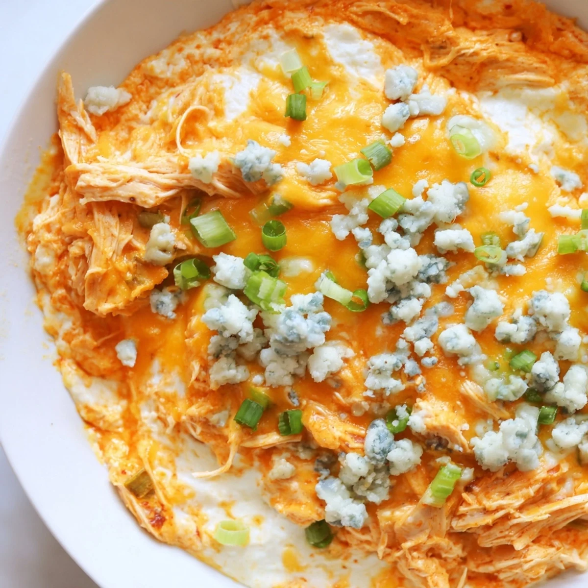 Spicy Keto Buffalo Chicken Dip in a ceramic bowl, garnished with crumbled blue cheese and ready for game day.
