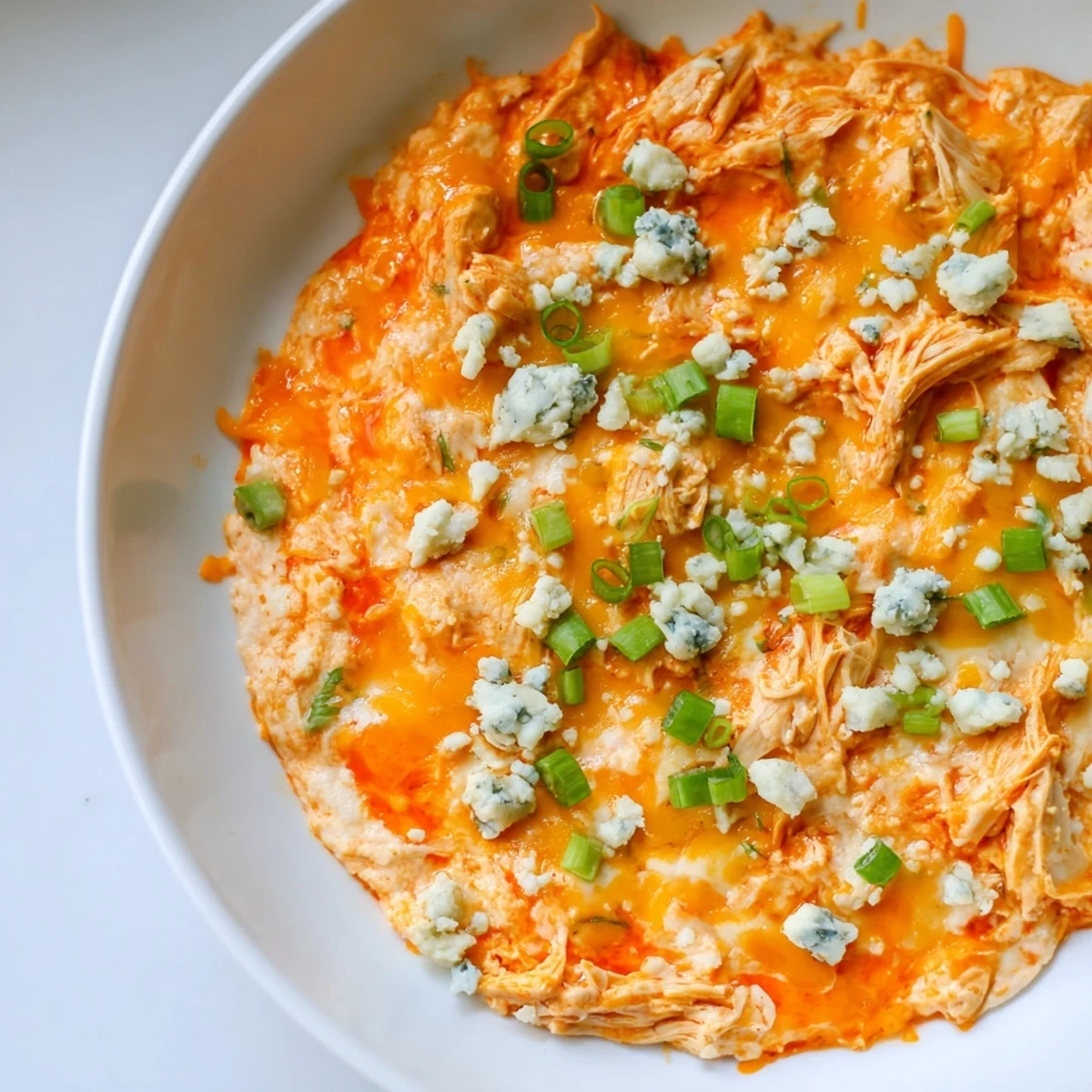 Keto Buffalo Chicken Dip served warm and creamy, topped with melty cheese and fresh green onions.