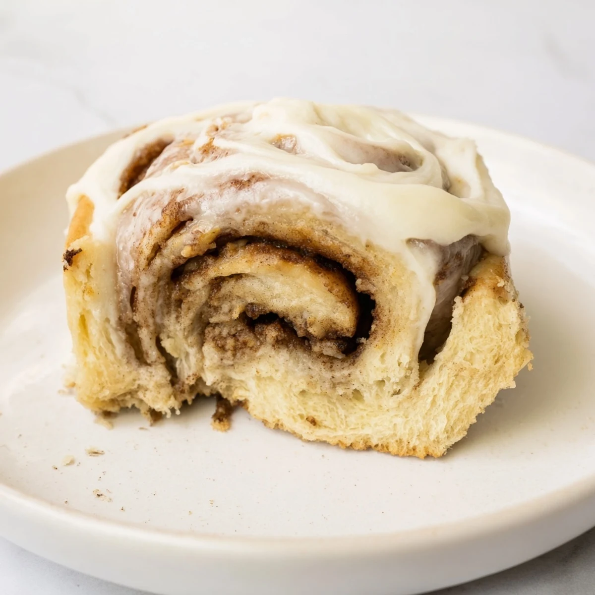 A close-up view of Keto Cinnamon Buns reveals the warm, gooey cinnamon filling inside the low-carb, gluten-free pastry.  