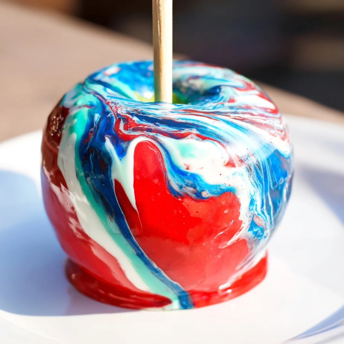 A close-up of Marbled Effect Candy Apples reveals a crunchy candy shell with bright marbled hues, perfect for festive parties and autumn gatherings.