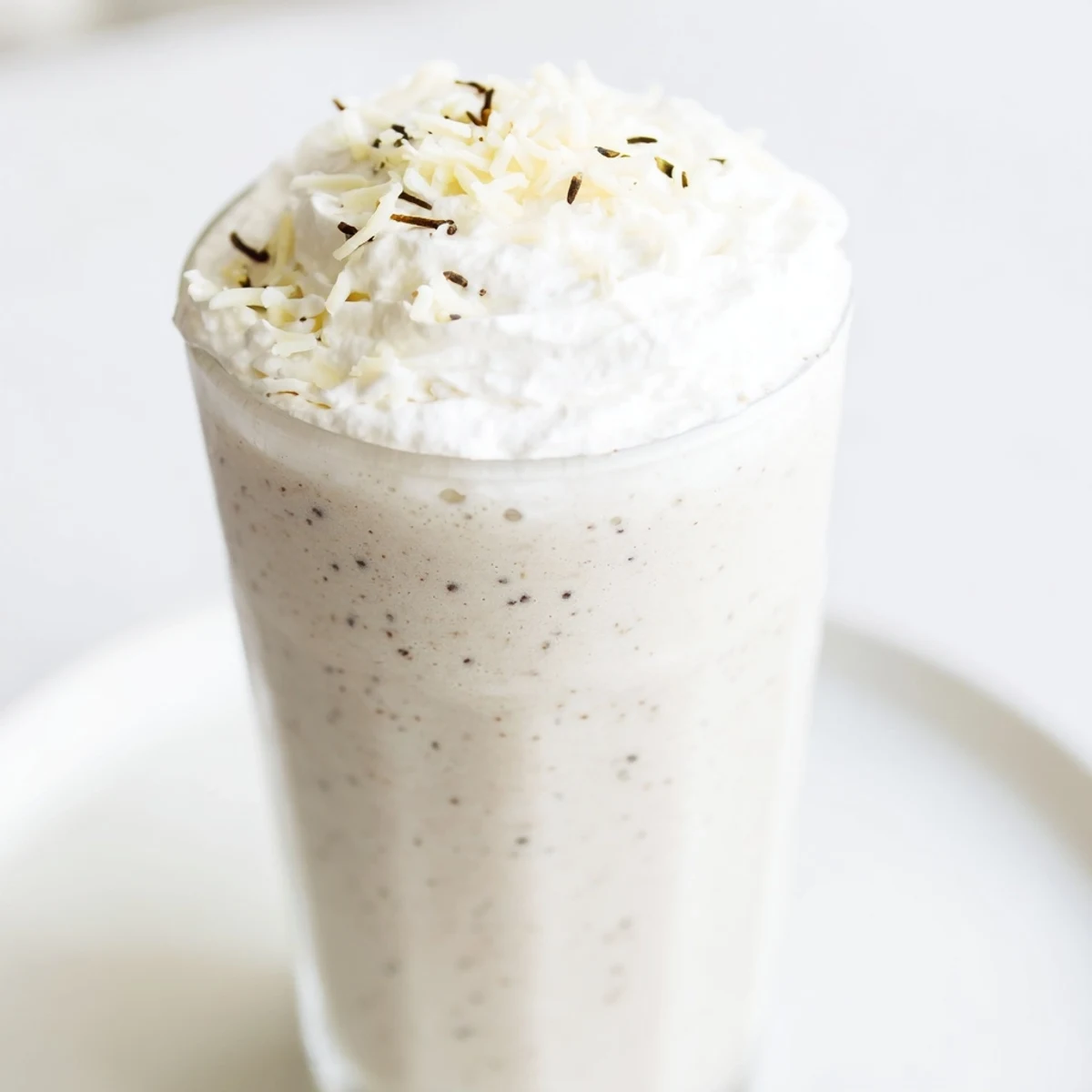 Chilled Vanilla Bean Frappuccino blending whole milk, sugar, and ice for a refreshing treat.