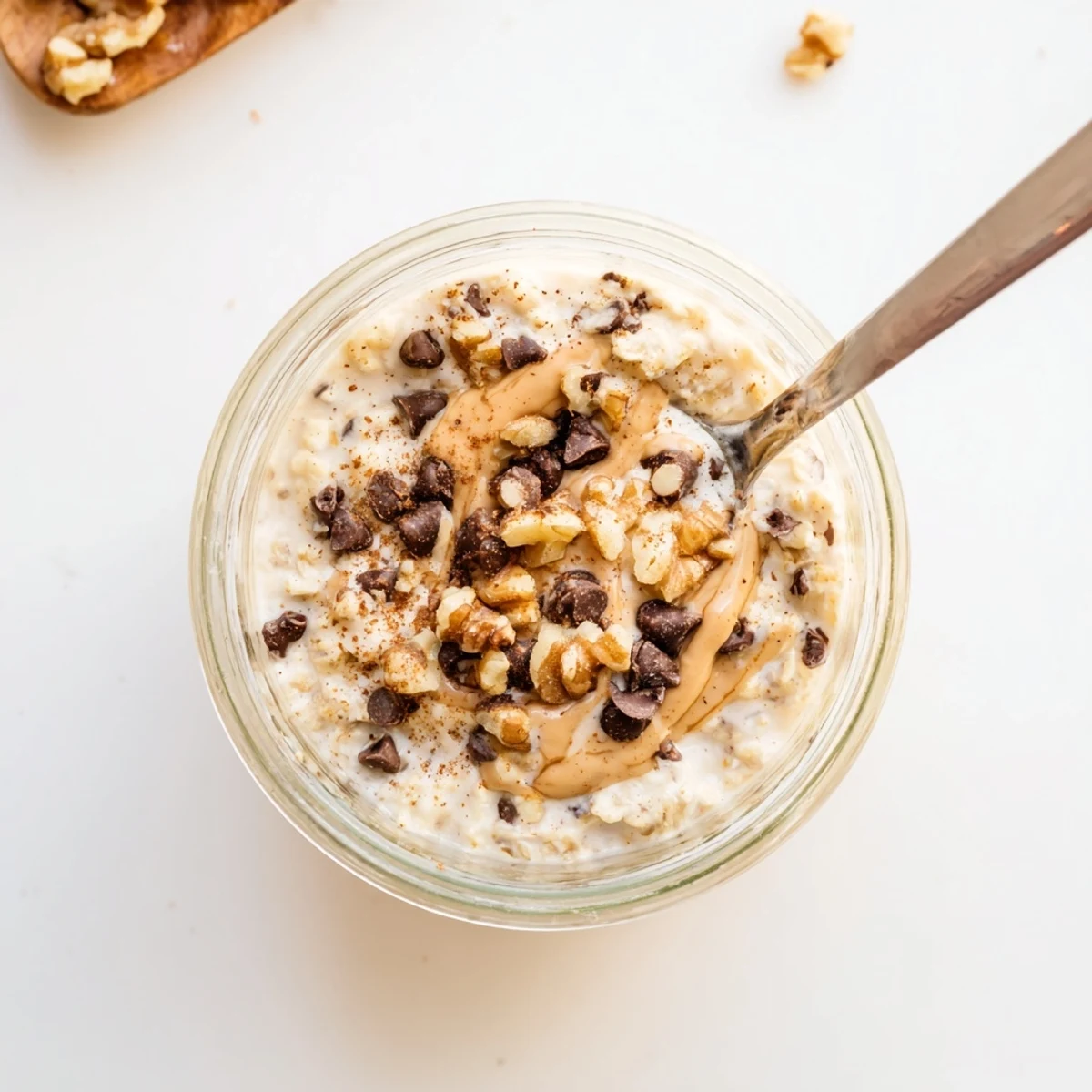 Cold Cookie Dough Overnight Oats layered with Greek yogurt and maple syrup in a jar.