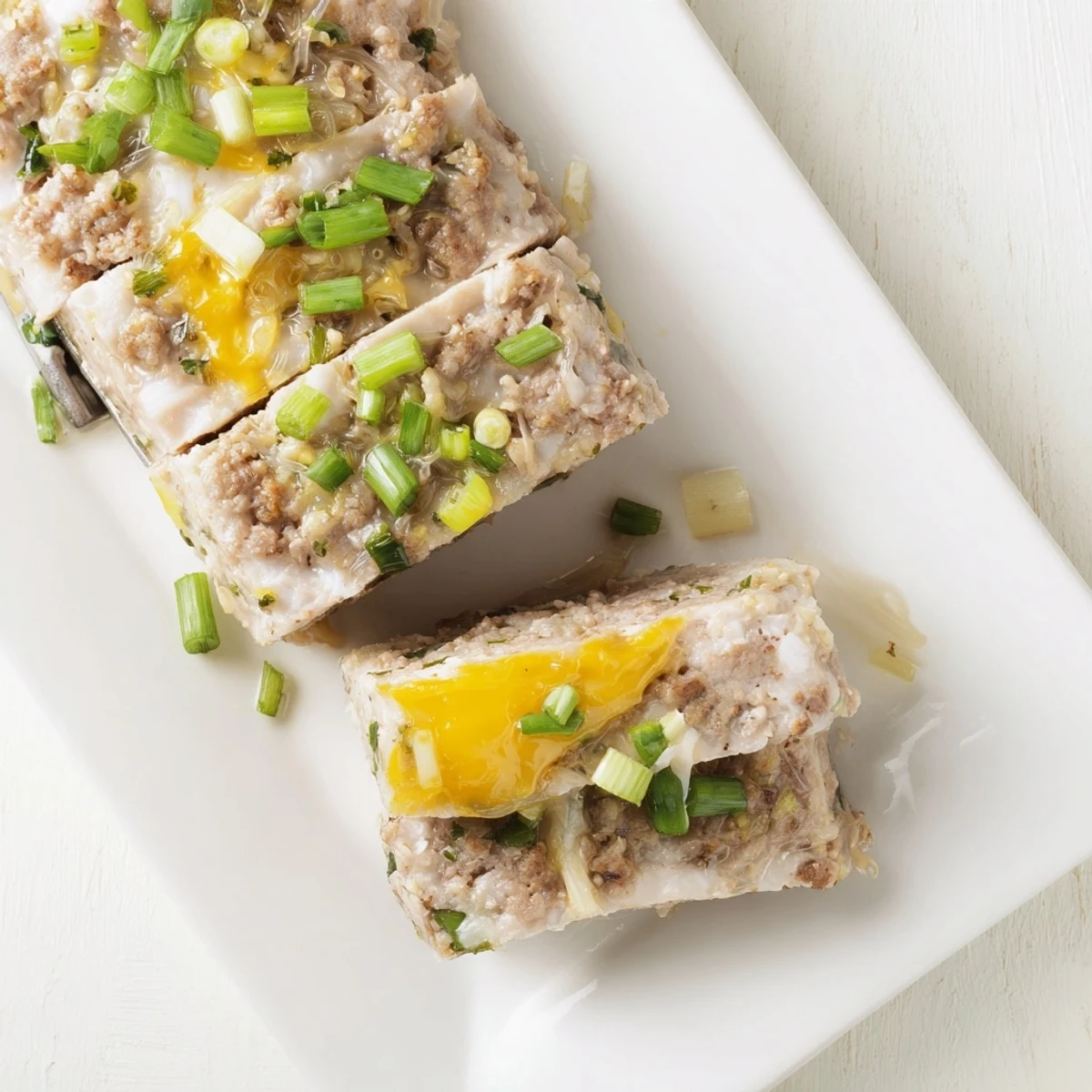Soft, savory Cha Trung Hap steamed pork and egg meatloaf with golden yolk topping, sliced and served with jasmine rice.