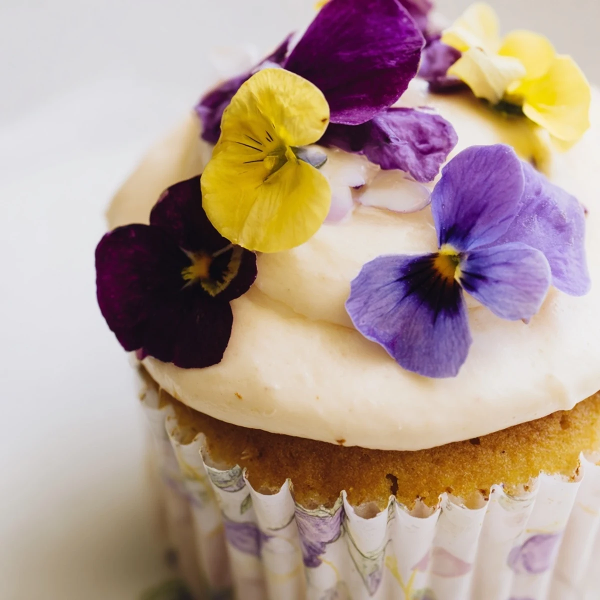 Freshly baked Wild Flower Cupcakes topped with light buttercream and edible calendula petals, perfect for afternoon tea.