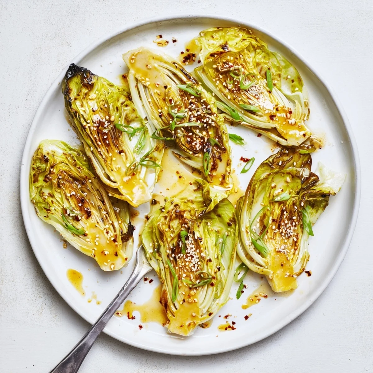 Golden brown miso butter roasted cabbage wedges drizzled with savory umami glaze