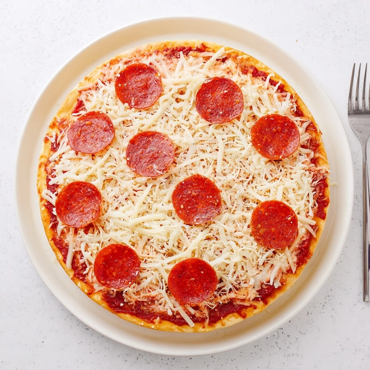 Authentic pan pizza fresh from oven with chewy interior and perfectly browned edges