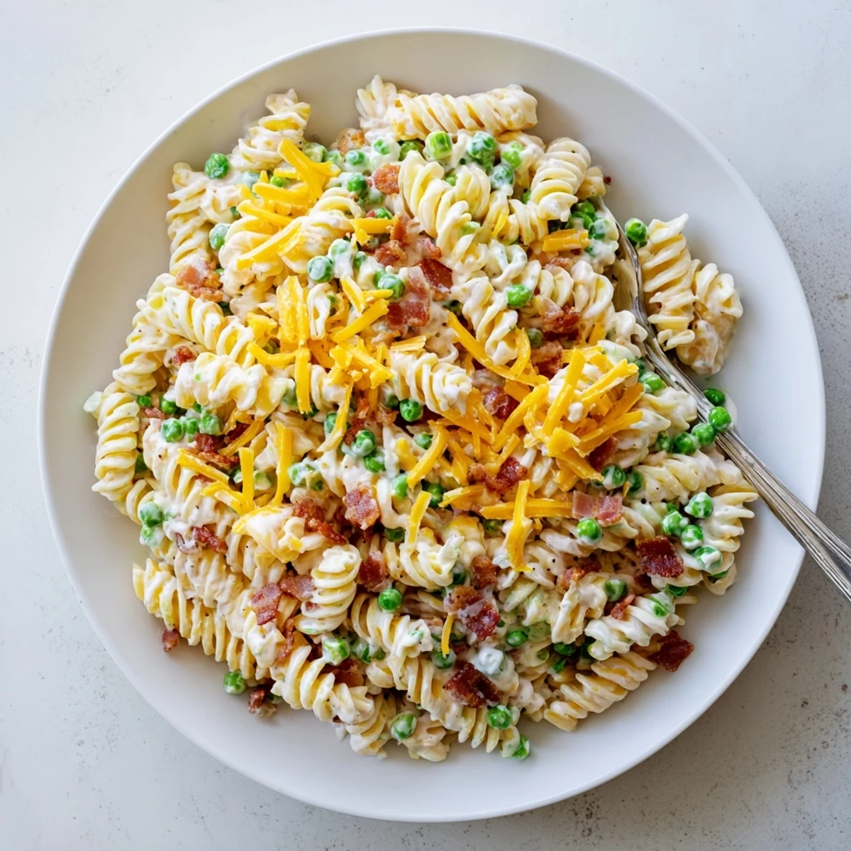 Creamy ranch pasta salad loaded with crispy bacon bits, sharp cheddar cheese, and green onions