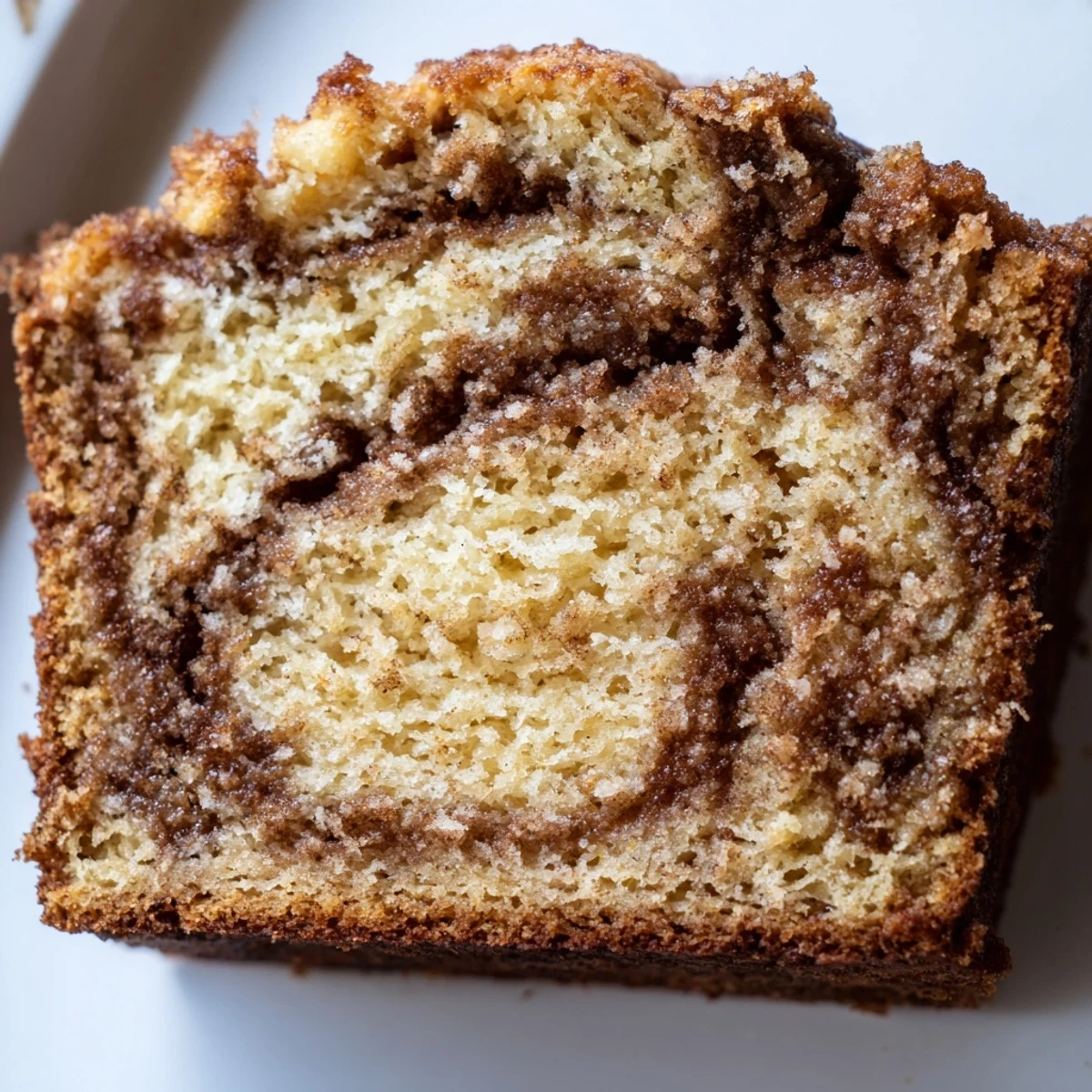 Cinnamon Sugar Swirl Banana Bread sliced thick, showing marbled cinnamon ribbons throughout the moist golden crumb