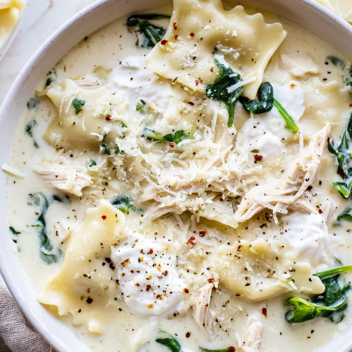 White lasagna soup with broken noodles spinach and rich creamy broth