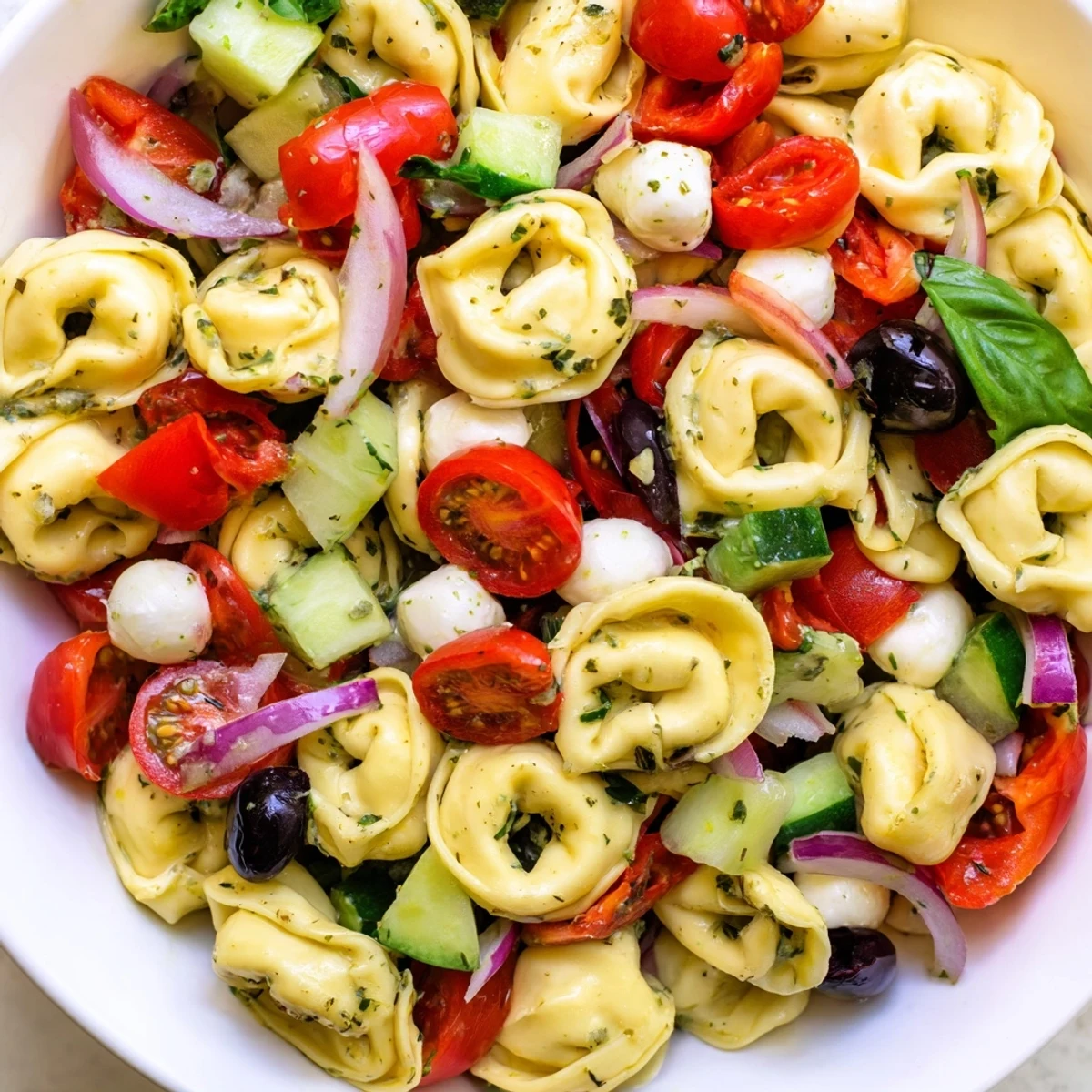 Cheese tortellini pasta salad tossed with crisp vegetables and zesty Italian dressing