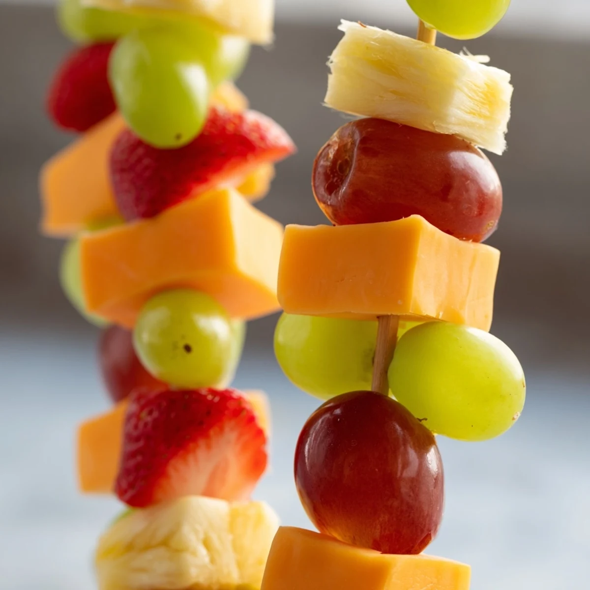 Juicy grapes and creamy cheese cubes threaded onto wooden skewers for easy party appetizer