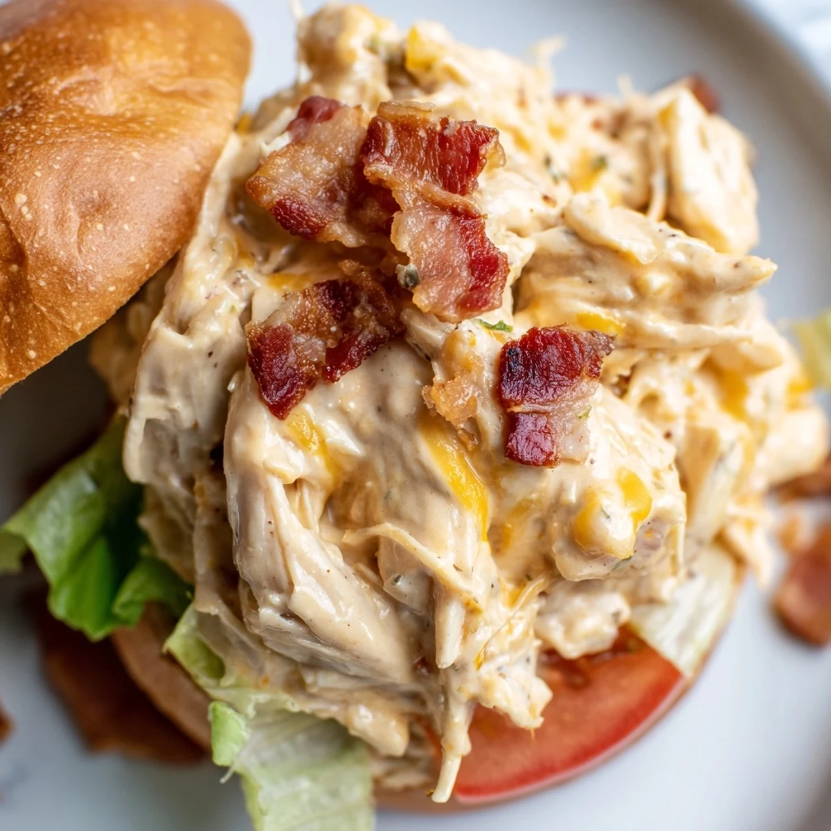 Baked Crack Chicken Sandwiches scooped hot from dish, topped with pickles