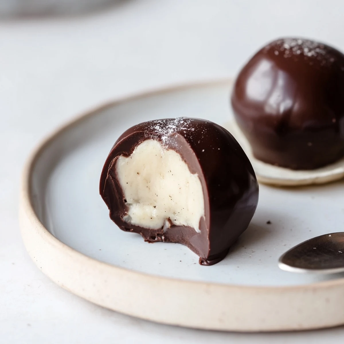 Plated Dark Chocolate Eggnog Truffles dusted with nutmeg, ideal for gifting