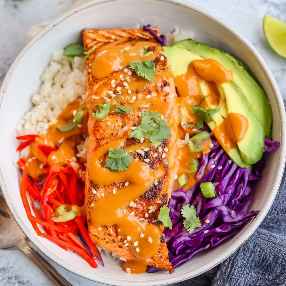 Bang Bang Salmon Bowls with roasted flaky salmon, creamy spicy sauce, avocado