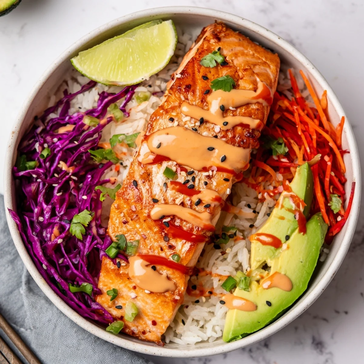 Oven-roasted Bang Bang Salmon Bowls drizzled with creamy sriracha-honey sauce