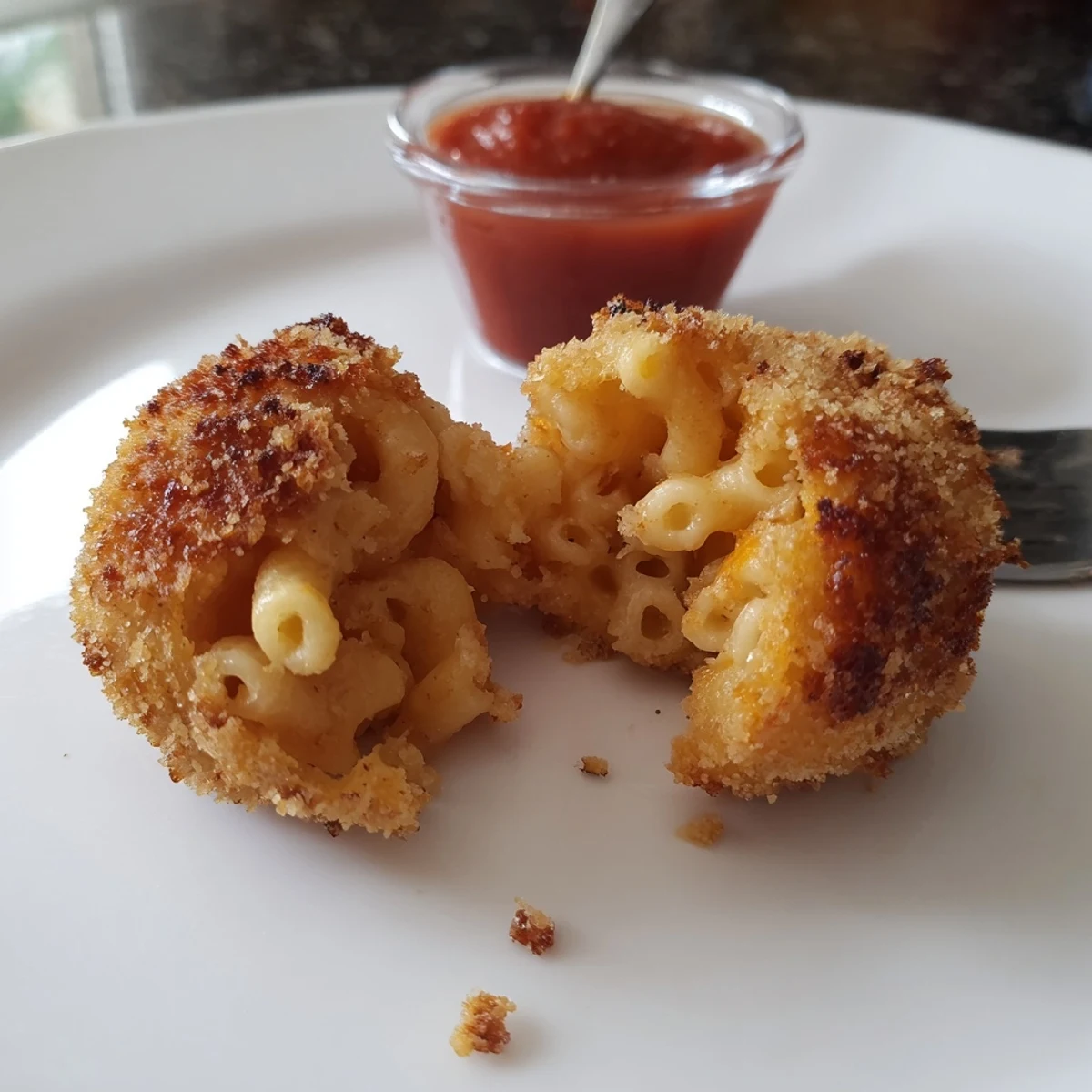 Golden, crispy Fried Mac And Cheese Bites with molten cheddar center, served warm