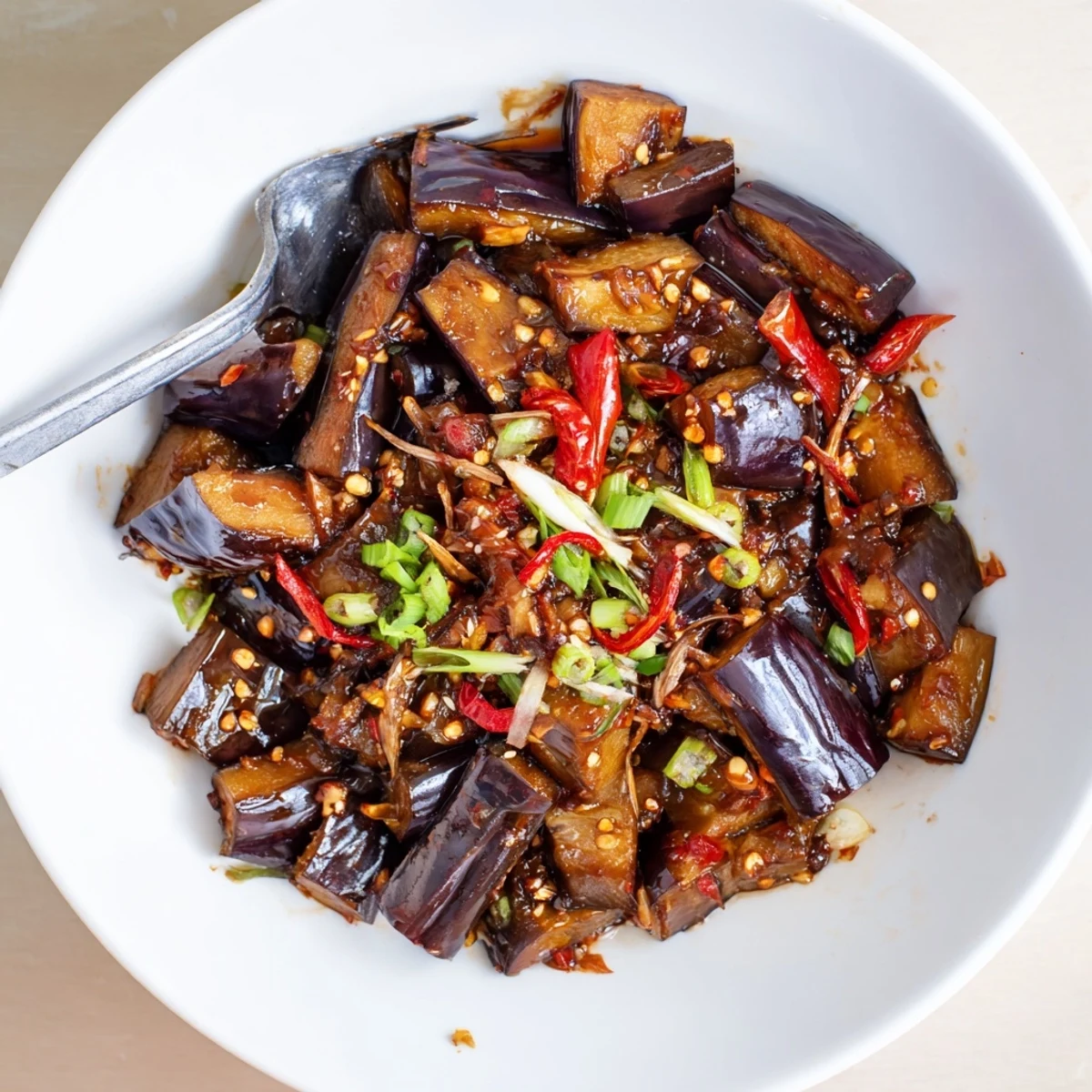 Sichuan Style Braised Aubergines spooned over steamed jasmine rice, fragrant and saucy.