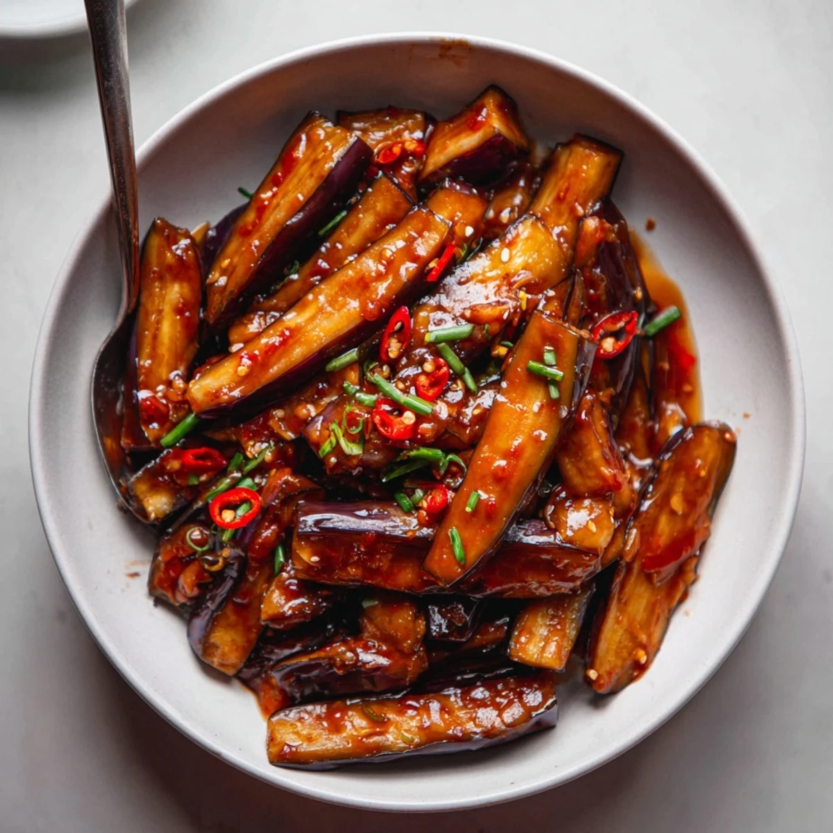 Tender batons of vegetables glazed with sesame — Sichuan Style Braised Aubergines, aromatic.