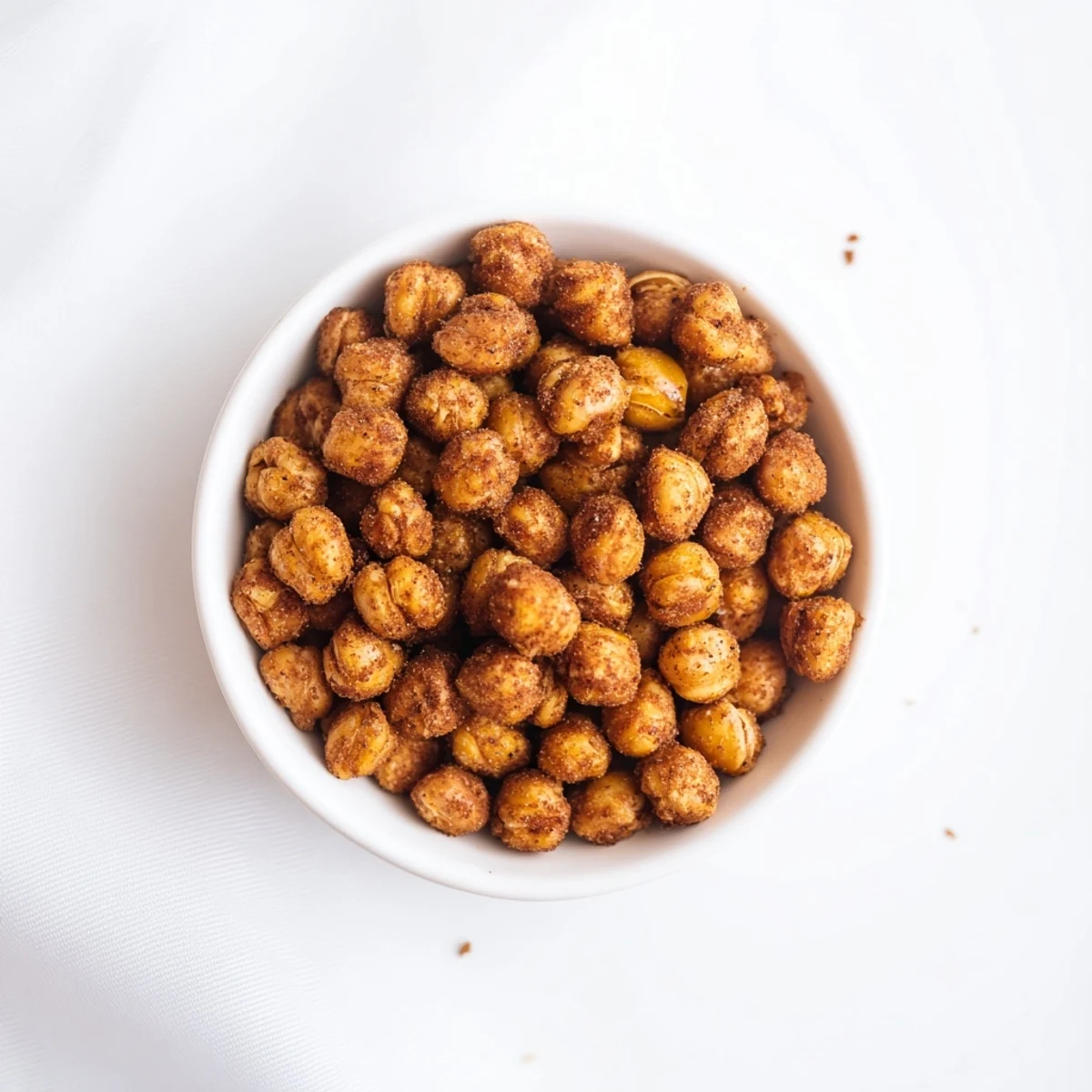 Bowl of crunchy cinnamon roasted chickpeas dusted with nutmeg ready for serving