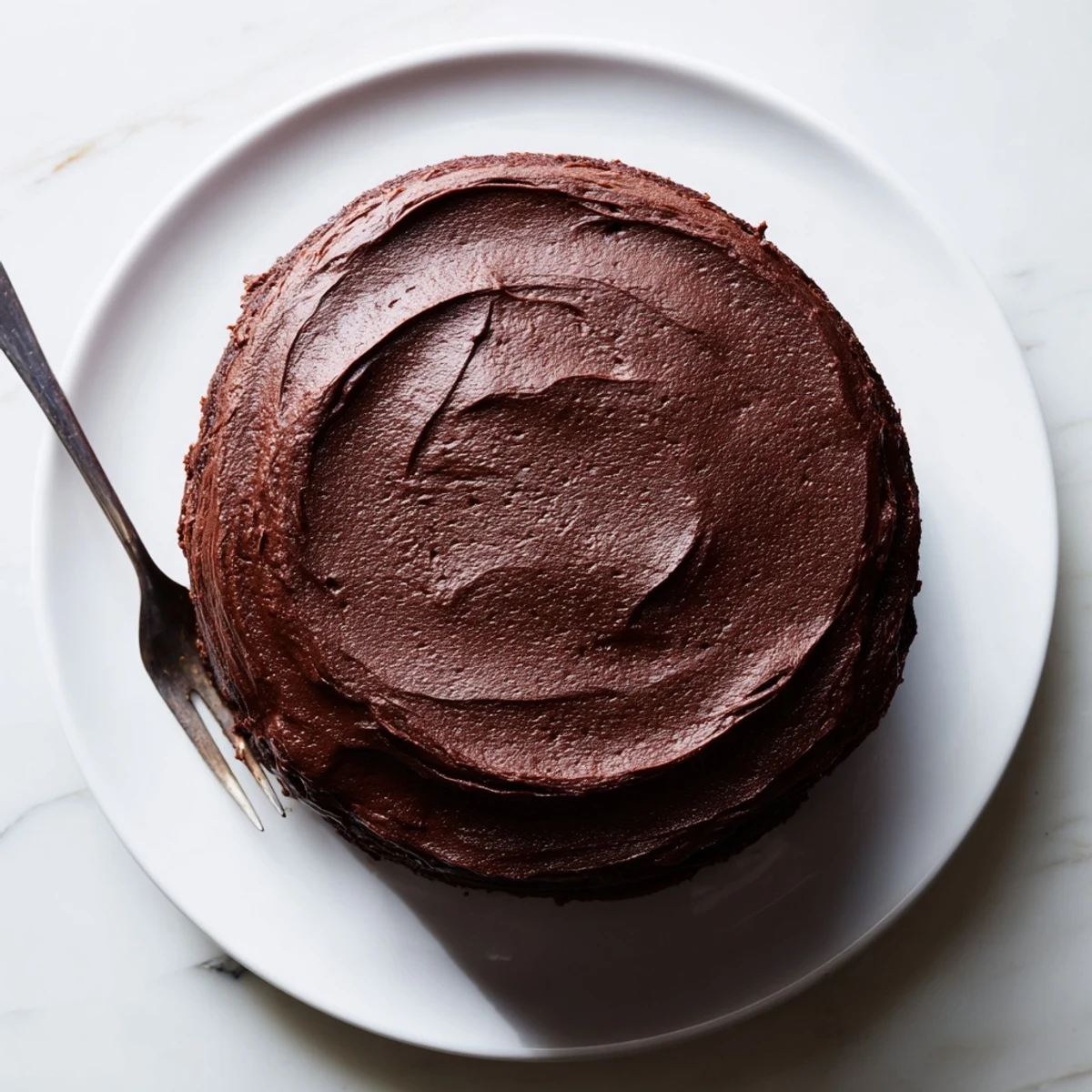 Slice of Matildas Chocolate Cake revealing moist dark crumb topped with creamy chocolate frosting