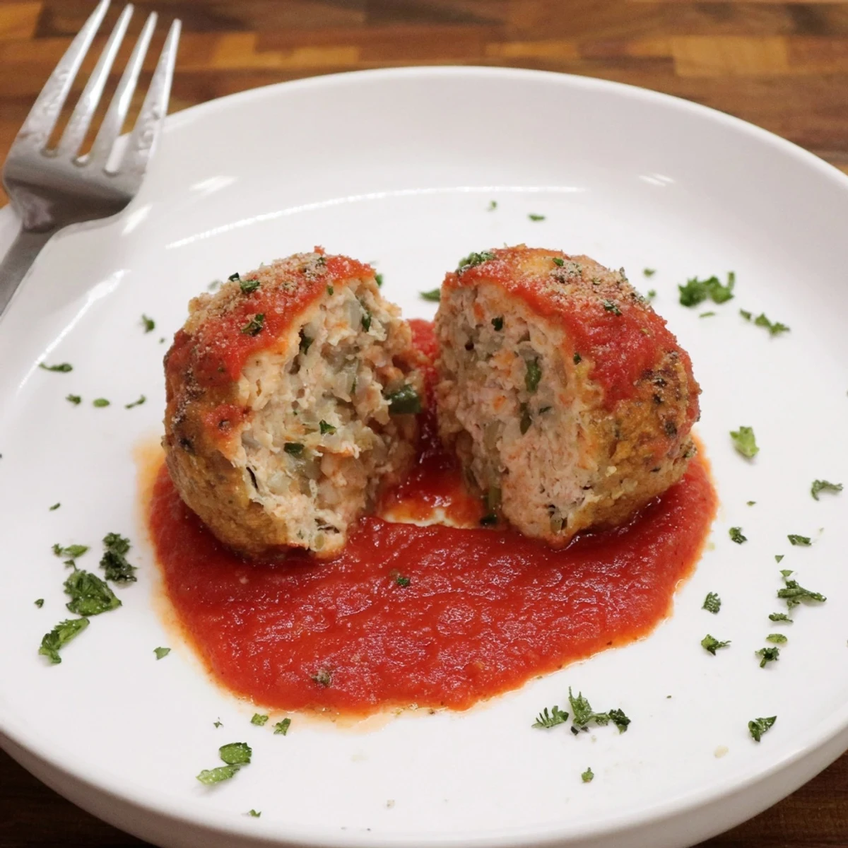 Family-style Juicy Chicken Meatballs piled over pasta, savory, herby, ready to serve