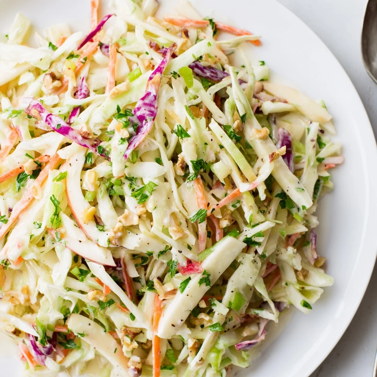 Bright Apple Coleslaw tossed in creamy honey-Dijon dressing, served alongside barbecue  