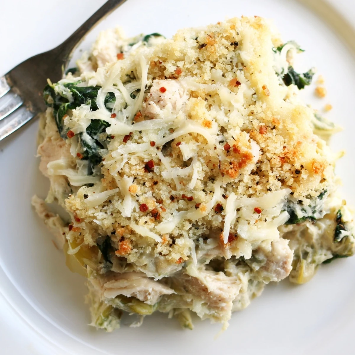 Creamy Spinach Artichoke Chicken Casserole in a 9x13 dish, ready for potluck