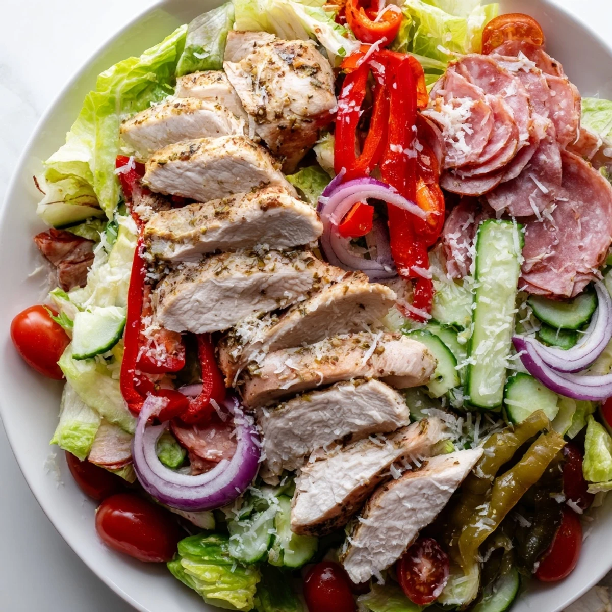 Italian Grinder Chicken Salad in a rustic bowl with juicy grilled chicken and fresh vegetables